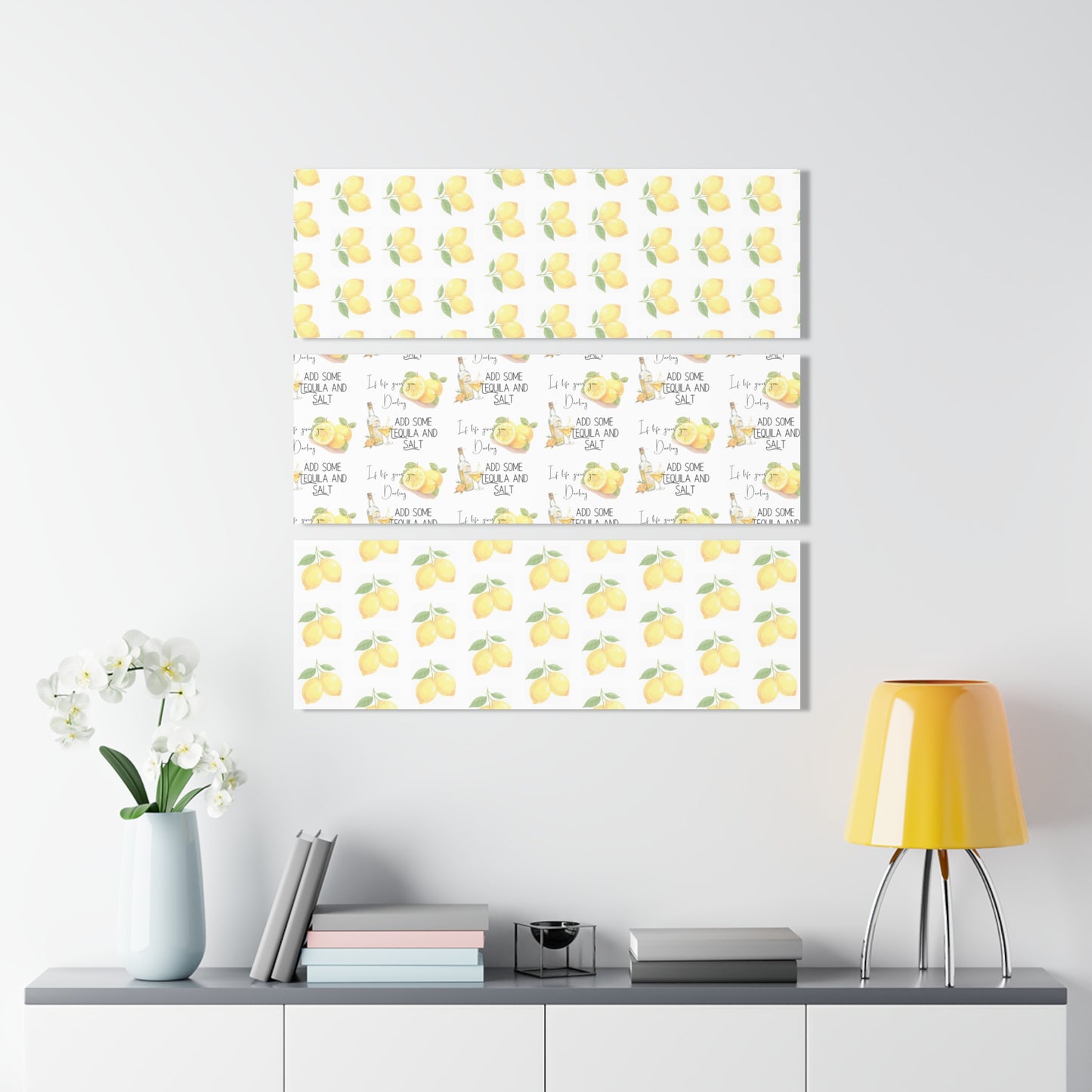 Three Acrylic Canvases with lemon-themed and if life gives you lemons ... darling ... add some tequila and salt wall art prints on a white wall above a shelf with decorative items.
