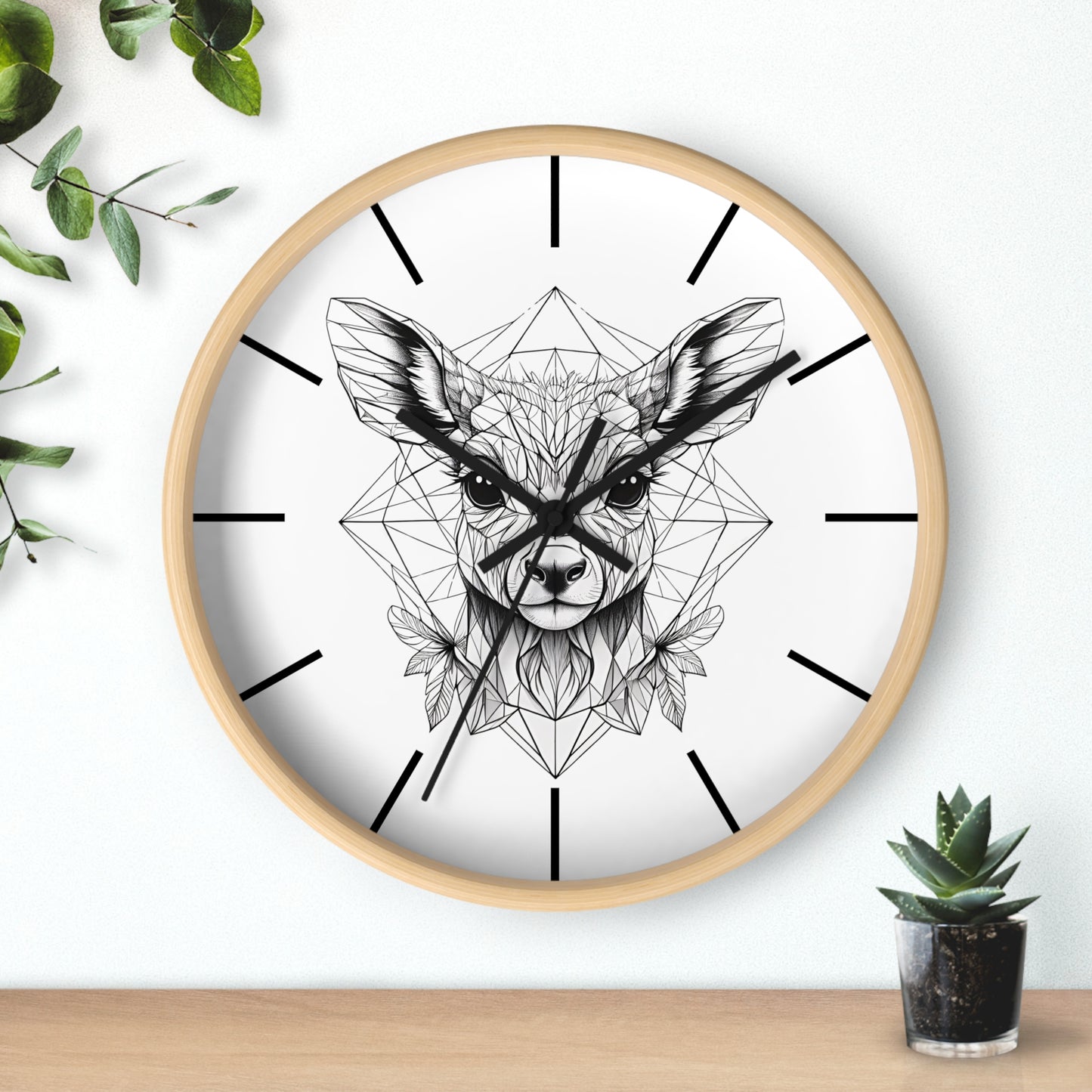 Wall clock with a bamboo frame and a line drawing of deer design on a white wall with greenery