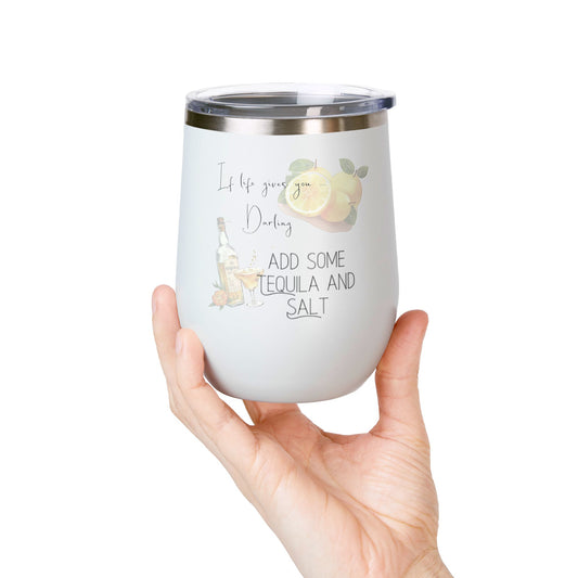 White tumbler with decorative text and design held by a hand on a white background